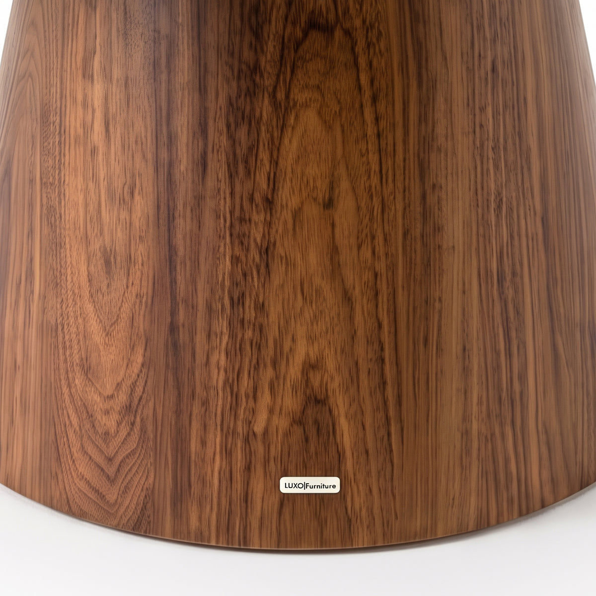 Close view of a wooden furniture base with visible wood grain on white background
