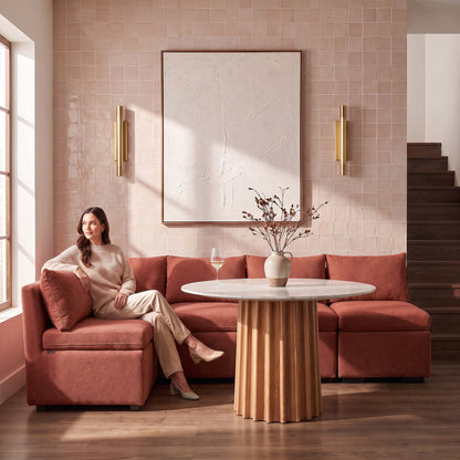 Rust terracotta sectional sofa with a woman seated in a stylish living room