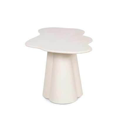 Modern side table with cloud-like top and three legs on a white background