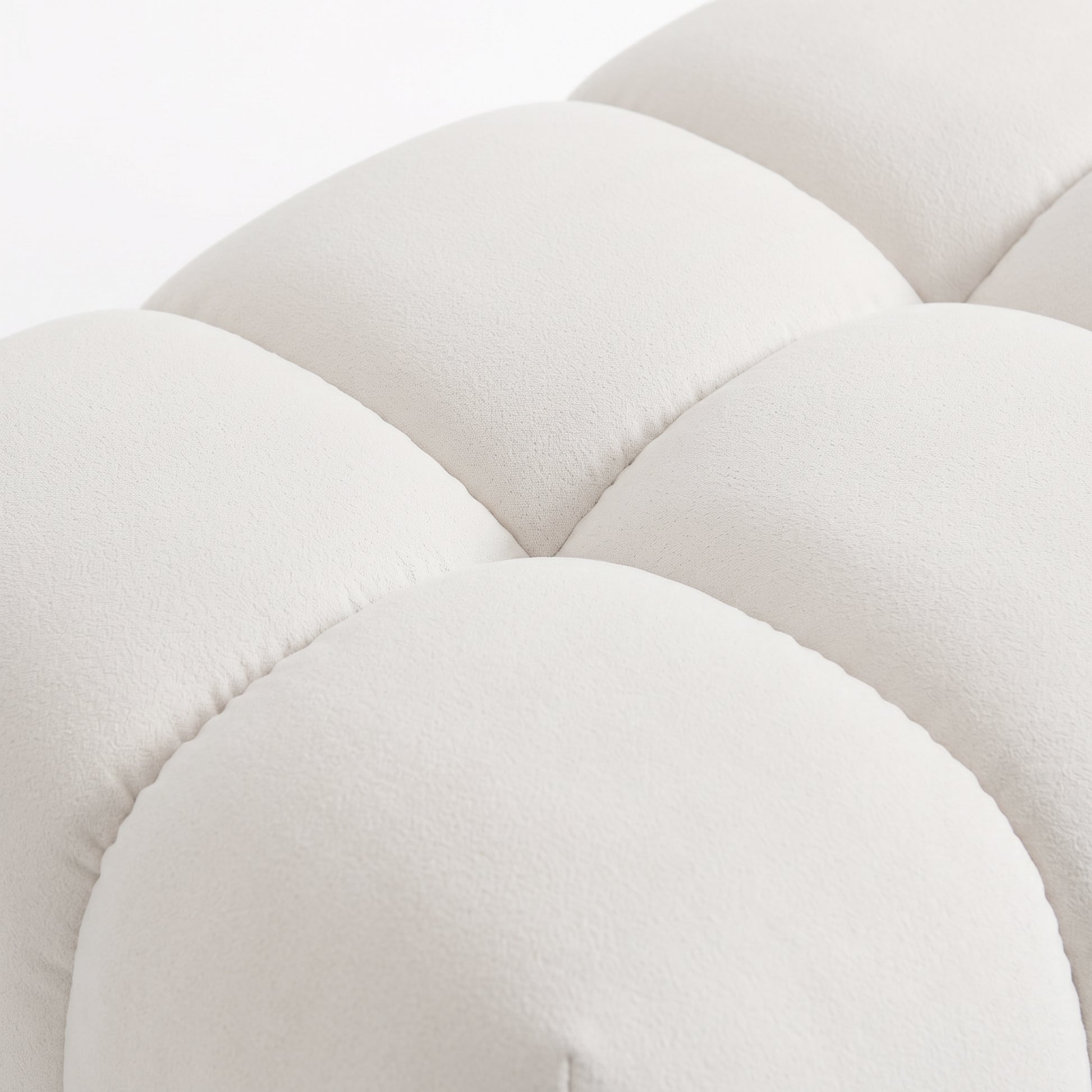 Close-up of light beige tufted upholstered fabric detail