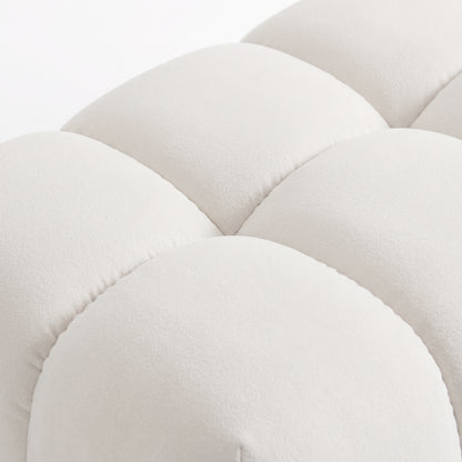 Close-up of light beige tufted upholstered fabric detail