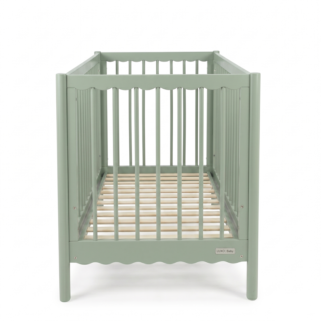 Sage green baby crib viewed from short end on white background
