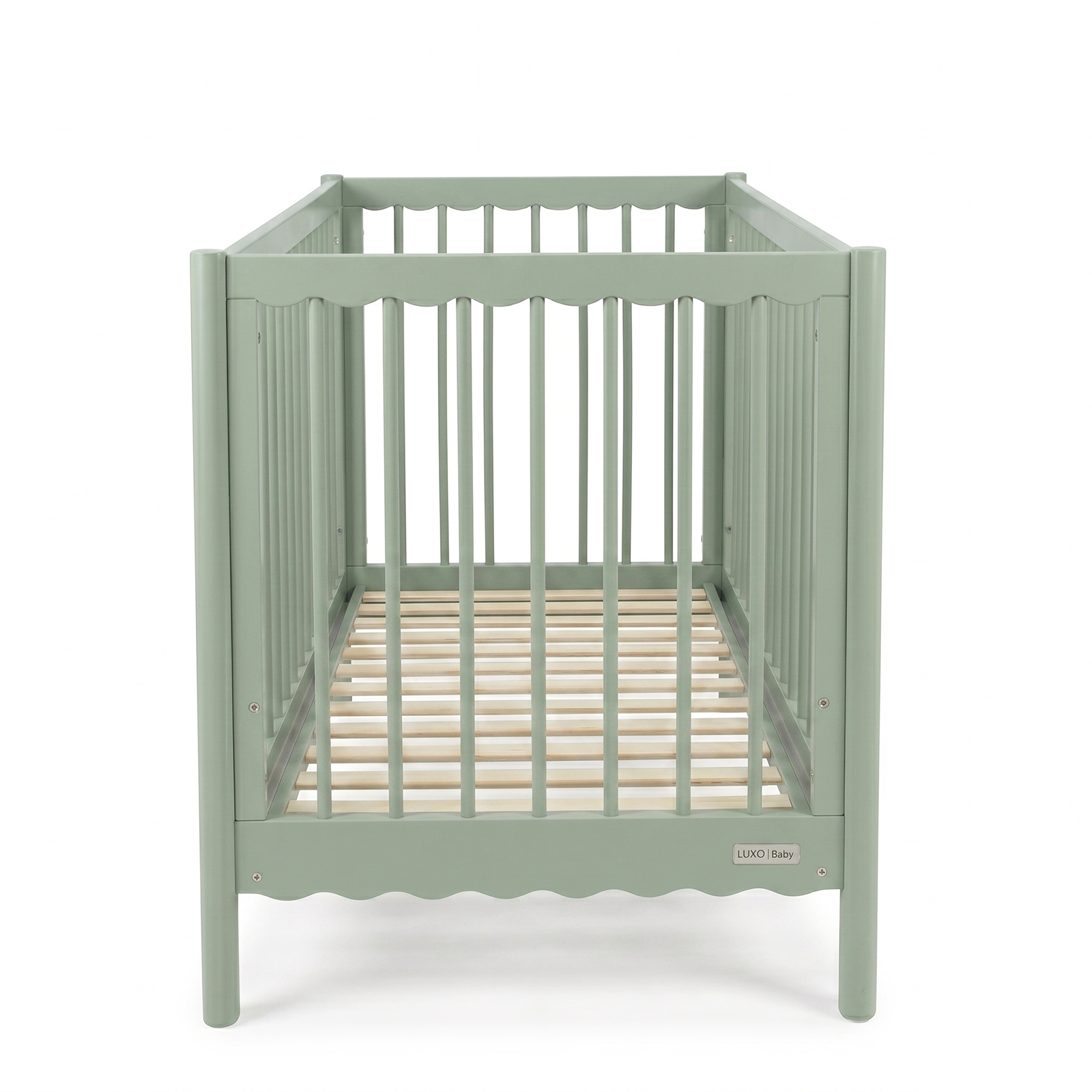 Sage green baby crib viewed from short end on white background