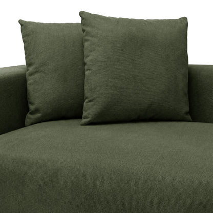 Partial view of green upholstered seating with back cushions on white background