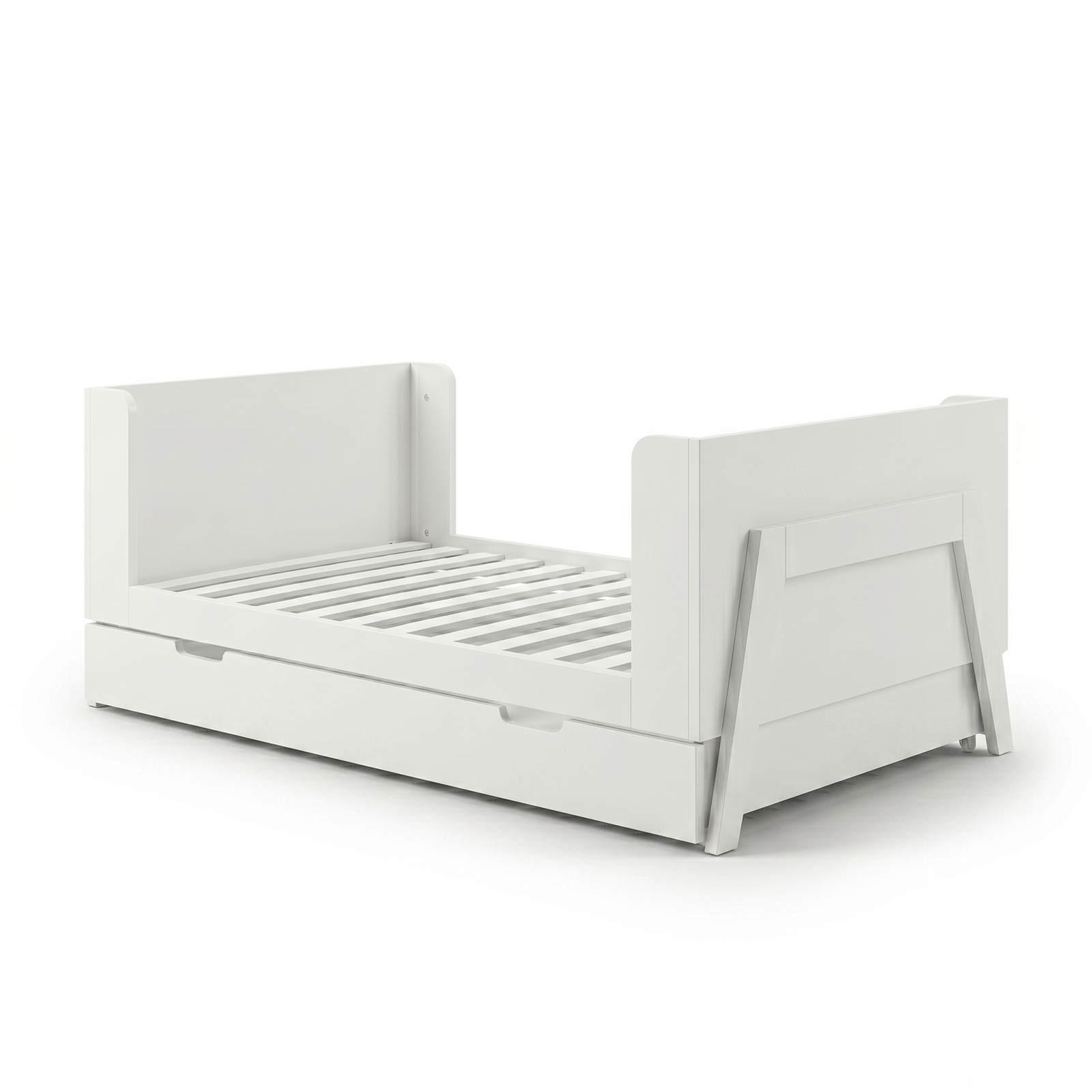White toddler bed frame on white background angled view showing trundle drawer
