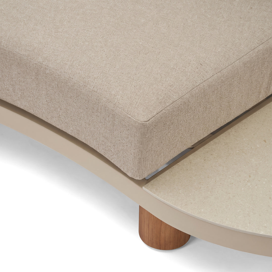 Close-up detail of beige upholstered furniture corner with wooden leg on a white background