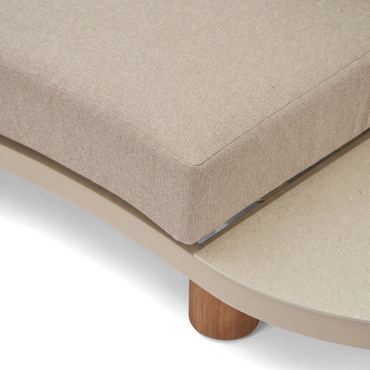 Close-up detail of beige upholstered furniture corner with wooden leg on a white background