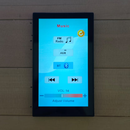 Touchscreen control panel displayed on a wooden surface