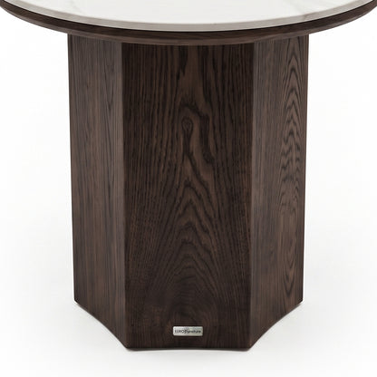 Elegant side table with a dark faceted wooden base and circular glass top on a white background