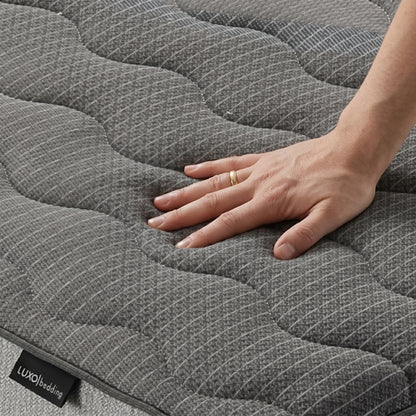 Hand pressing into textured mattress surface