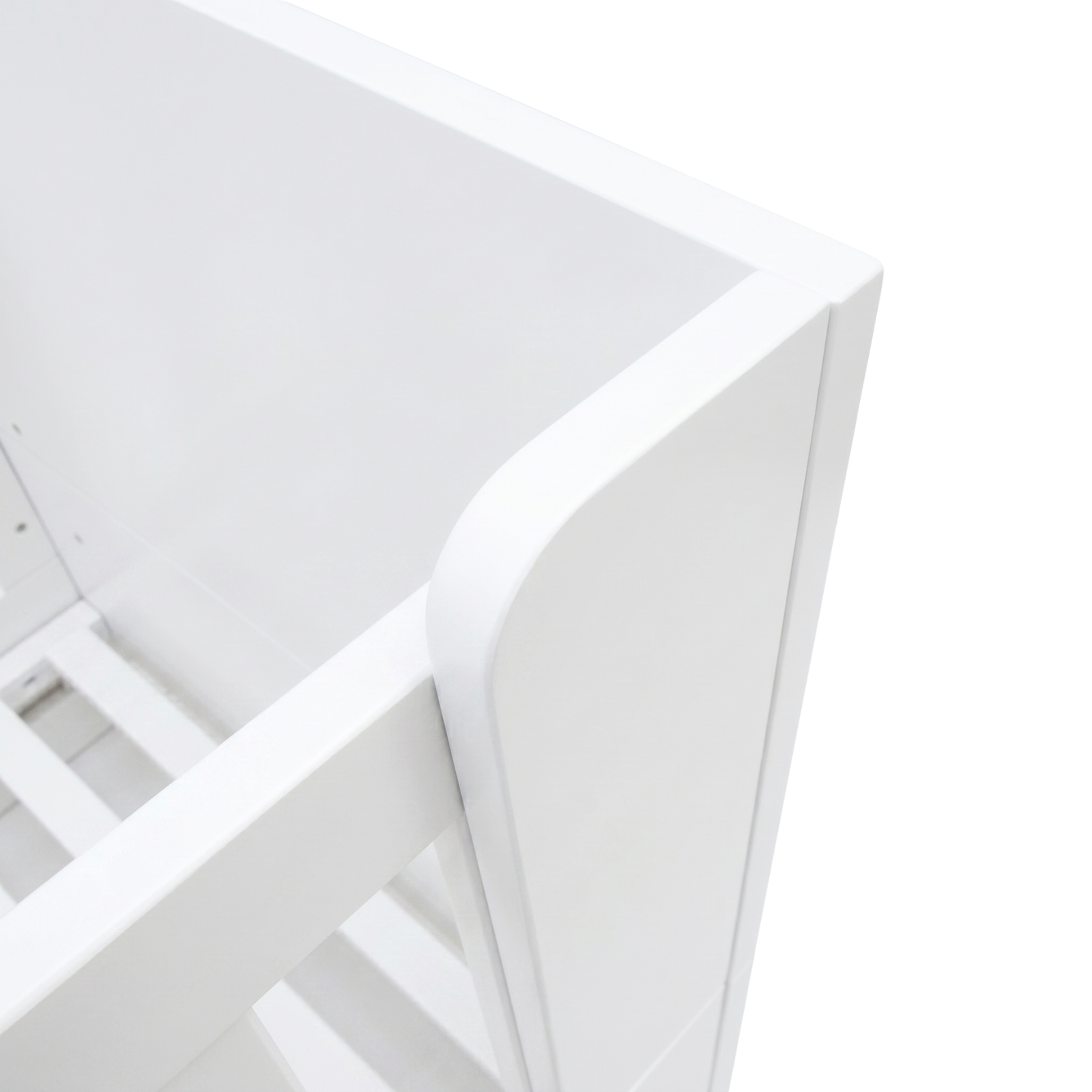 Close-up of white crib corner and slats on white background