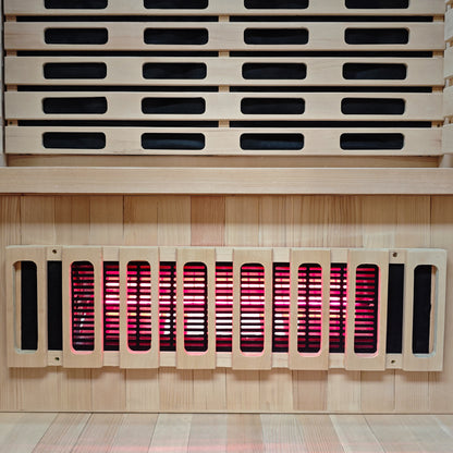 Close view of sauna interior wood slats and glowing heater element.
