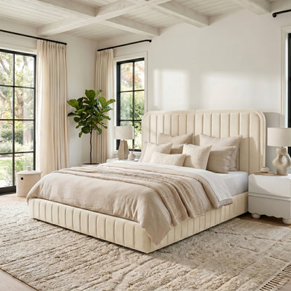 Upholstered bed with vertical channel headboard in a bright modern bedroom with neutral décor and plant