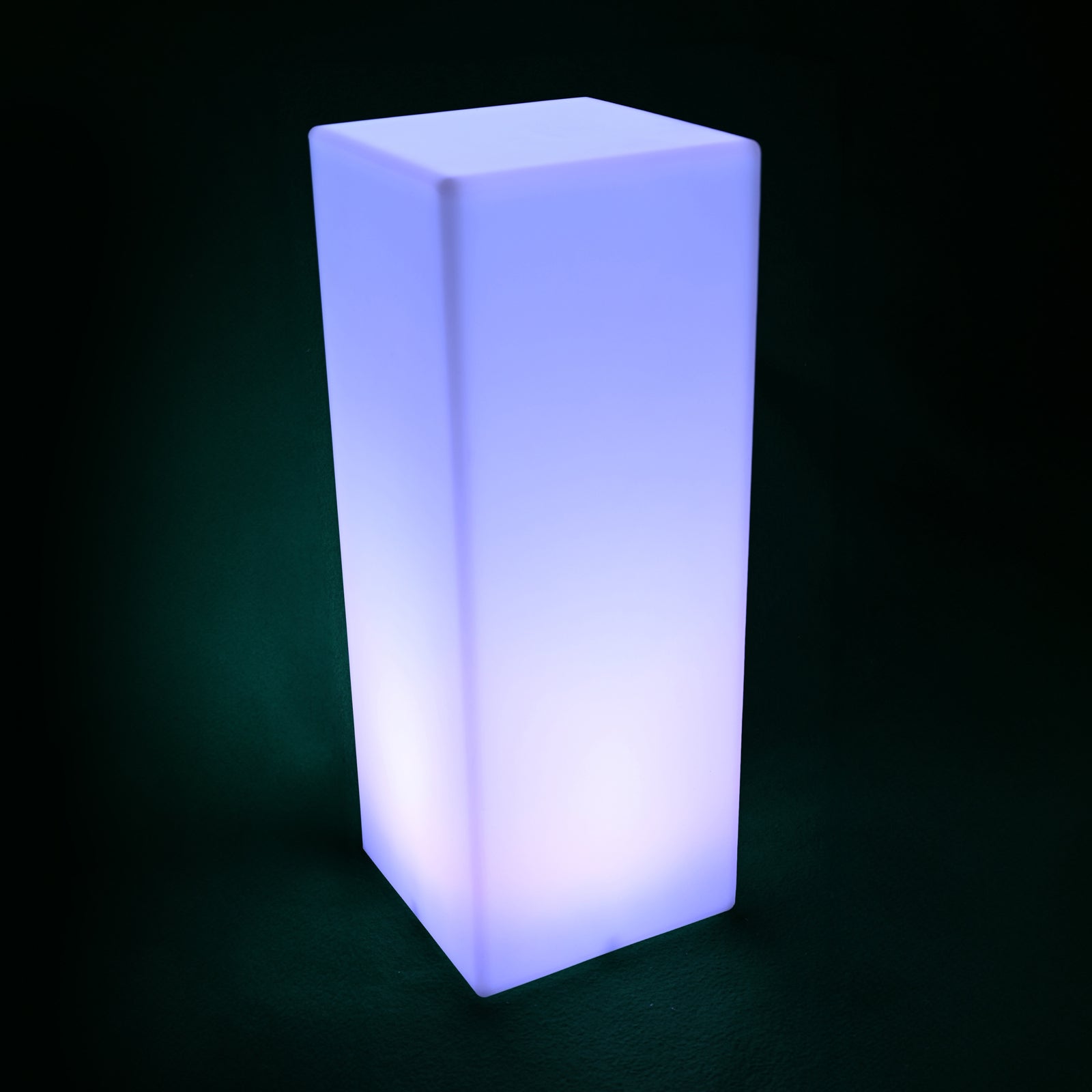 Colour Changing LED Column Light Indoor & Outdoor glowing bluish-purple, stands tall as a modern LED fixture, providing versatile mood lighting for any space, indoors or out.