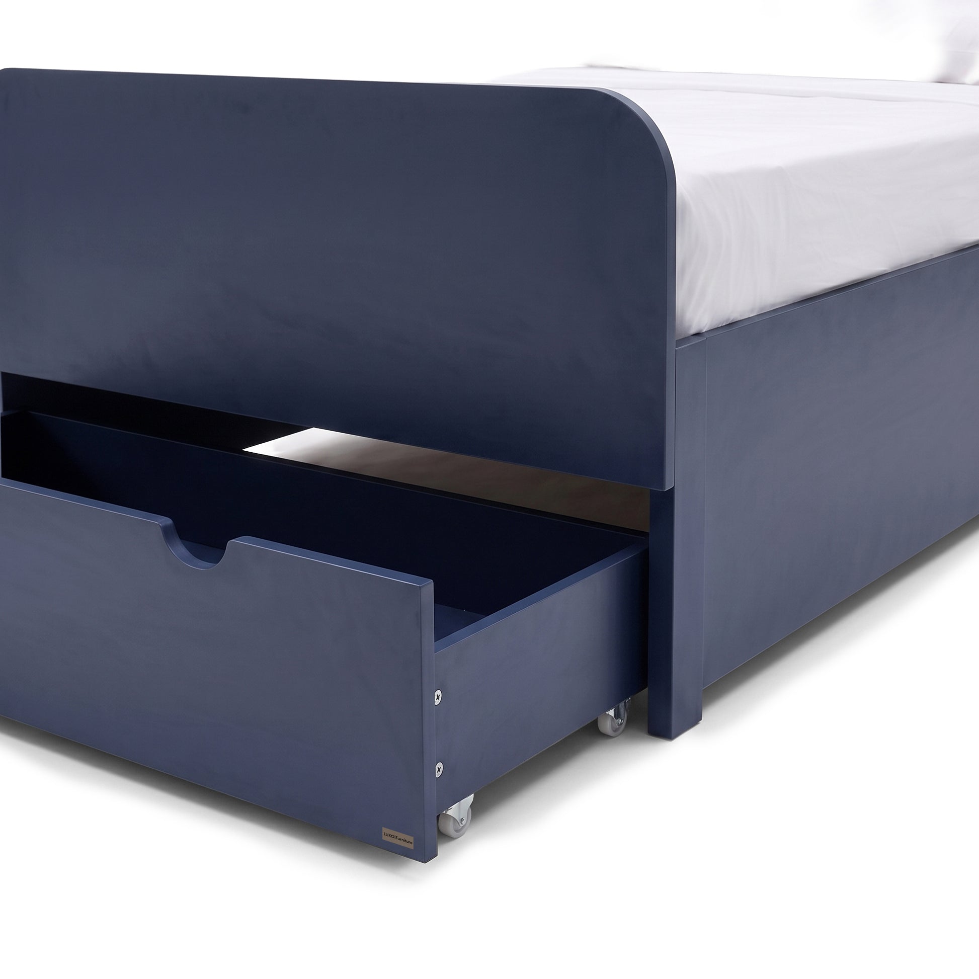 Close view of the lower section of a blue bed with open storage drawer