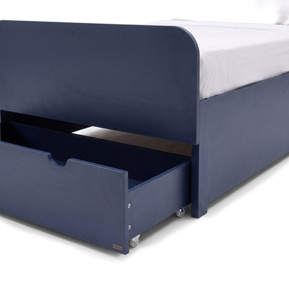 Close view of the lower section of a blue bed with open storage drawer