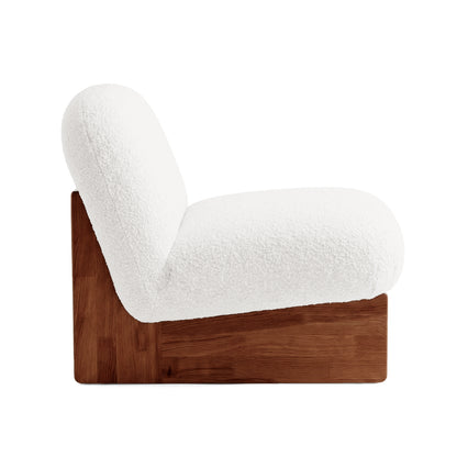 Side profile of lounge chair on white background.