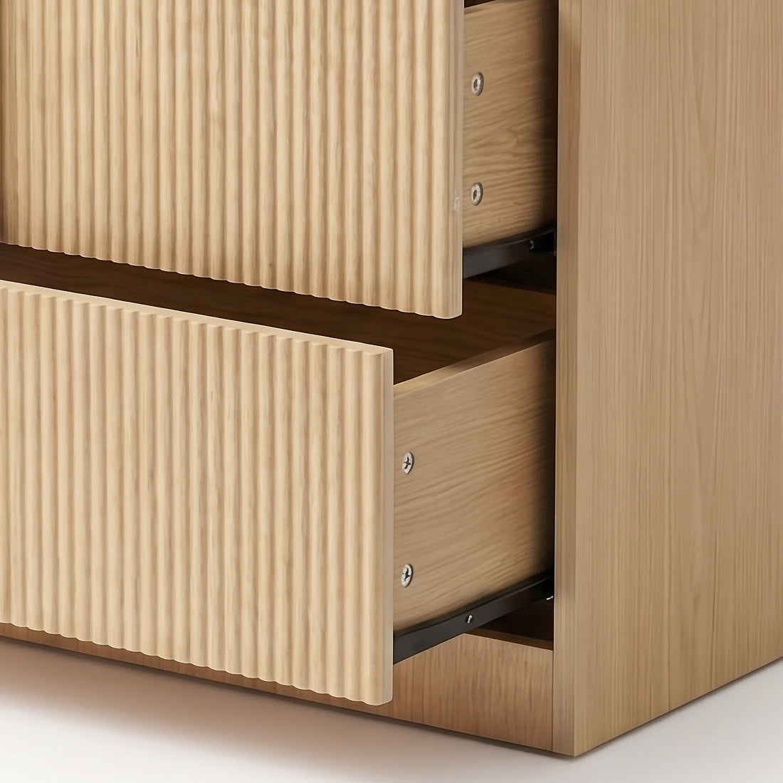Close-up of open dresser drawers showing ribbed fronts and interior slides