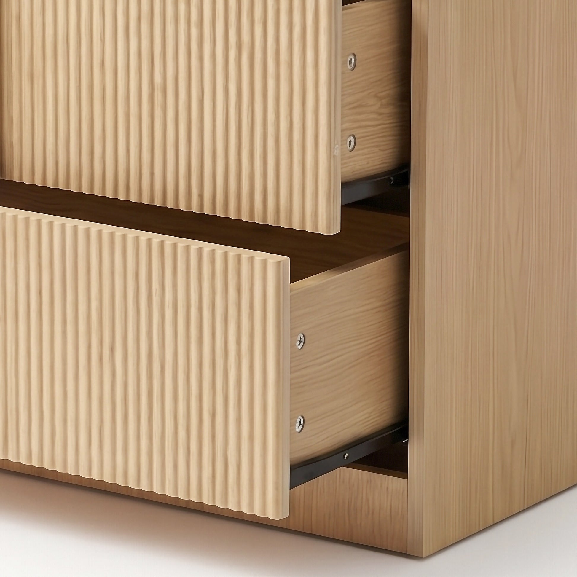 Close-up of open dresser drawers showing ribbed fronts and interior slides