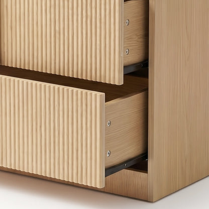 Close-up of open dresser drawers showing ribbed fronts and interior slides