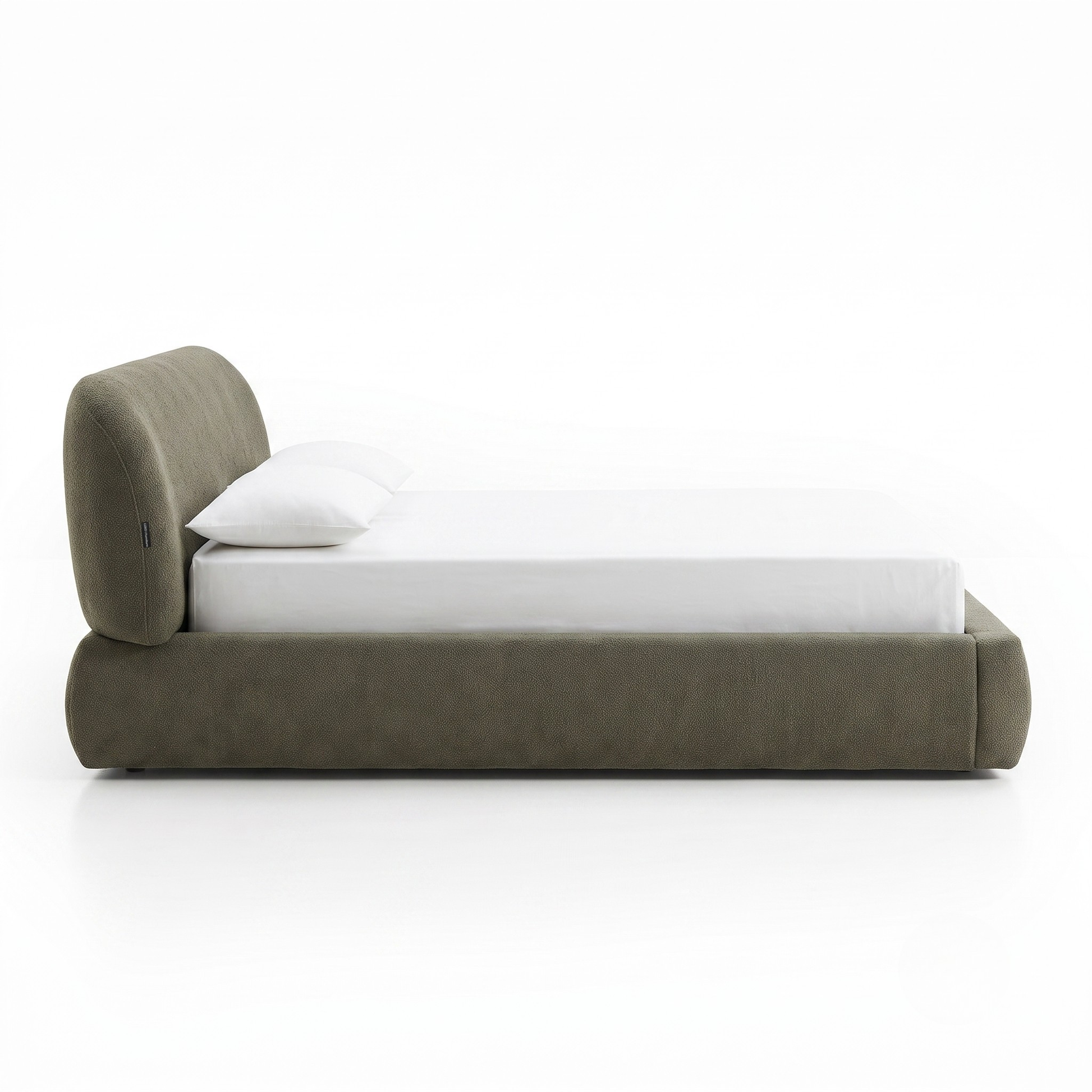 Side view of upholstered platform bed on a white background
