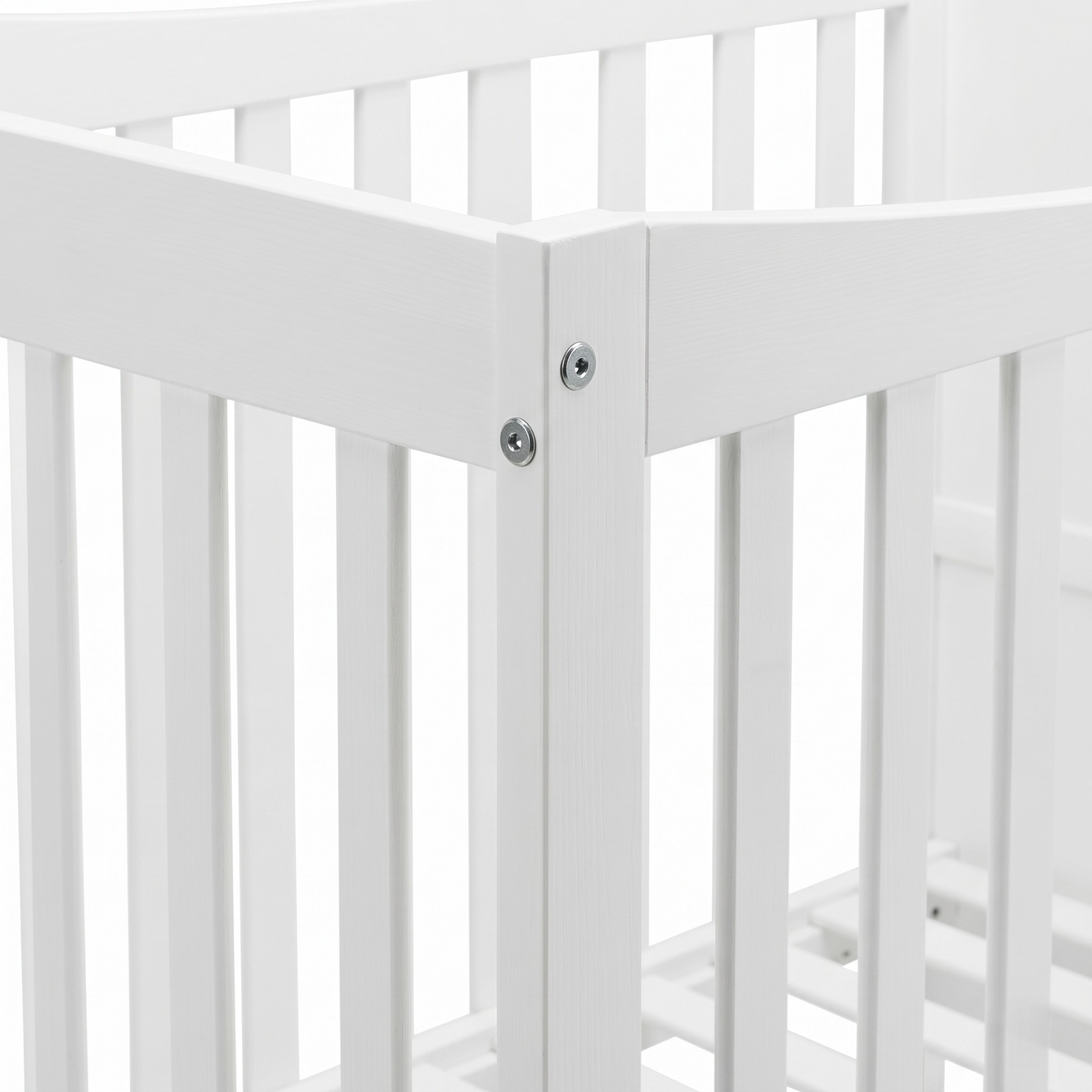 Close-up of white crib corner joint and slats