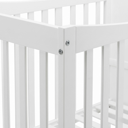 Close-up of white crib corner joint and slats