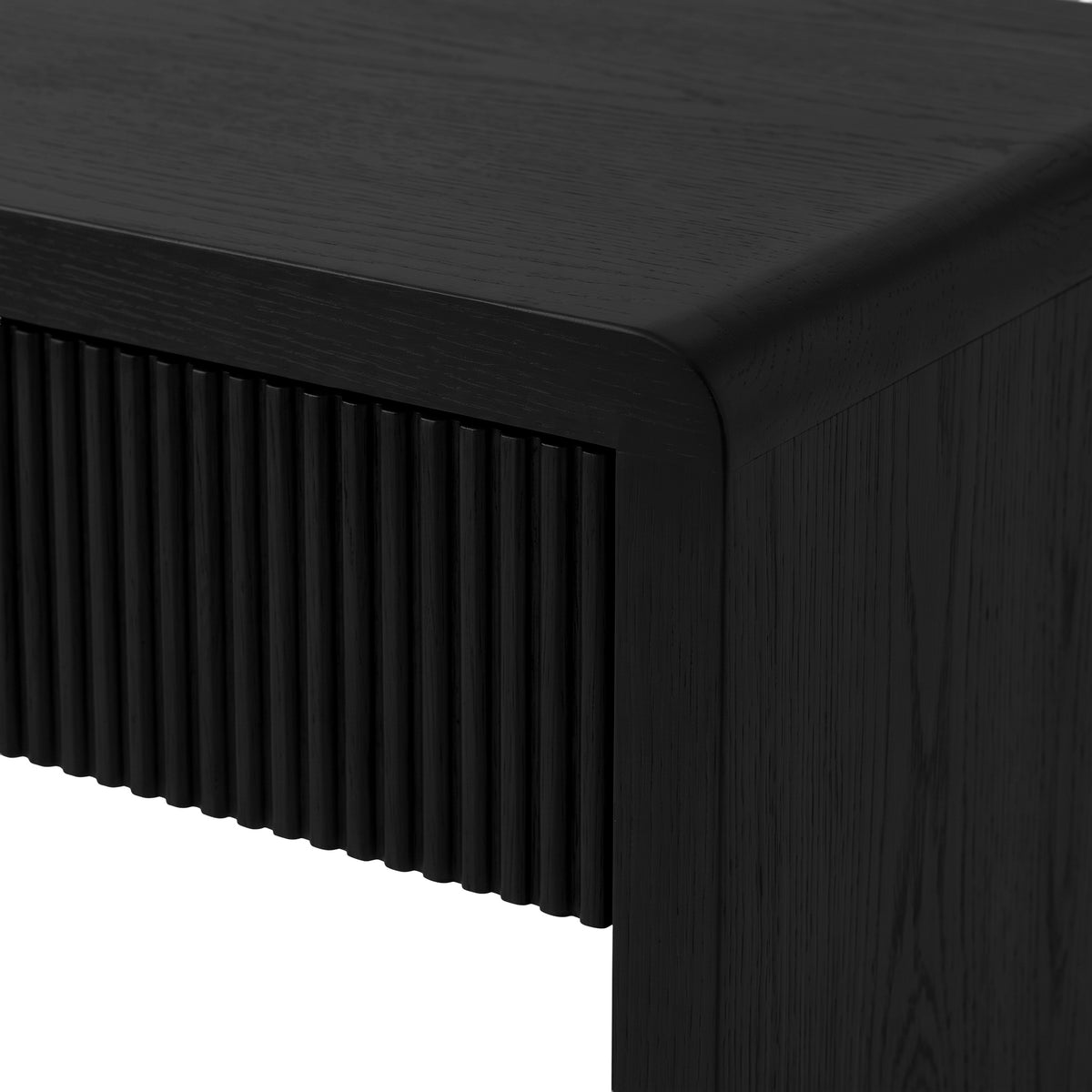 Close-up of the corner and ribbed surface of a black desk
