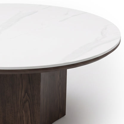 Close-up of a round table with a white marble-like top and dark wood base on a white background