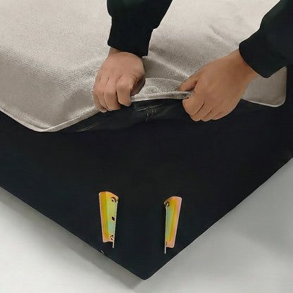 Hands unzipping beige fabric cover on furniture in a lifestyle setting