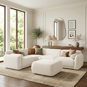 Cream sectional sofa with ottoman in a styled living room