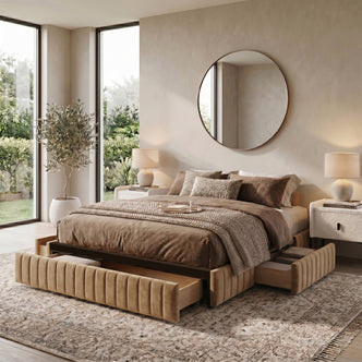 Upholstered bed with under-bed storage drawers in a styled bedroom with nightstands, lamps, and décor