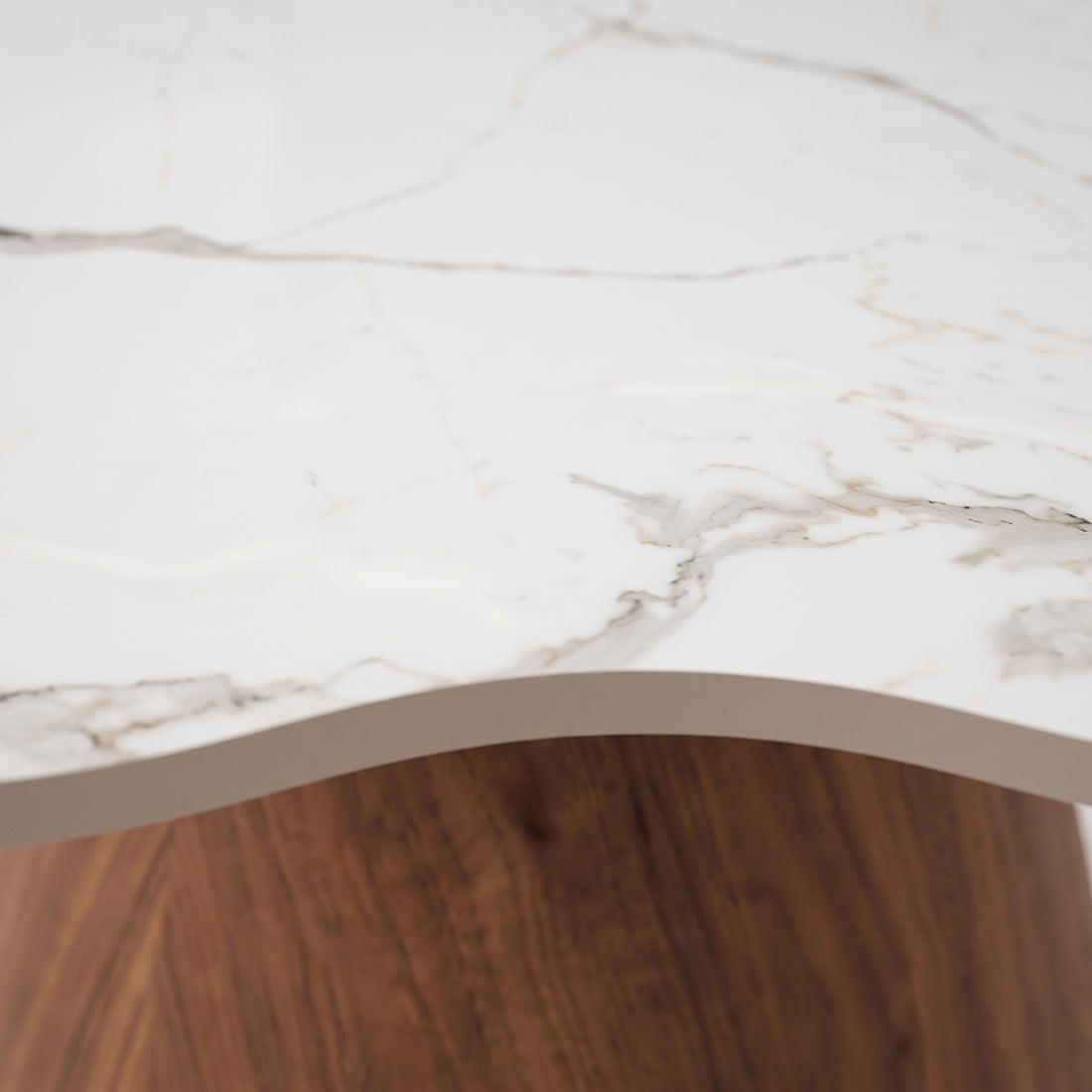 Close-up of marble-look tabletop edge and wooden base detail