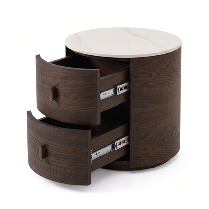 Round wooden side table with white top and open drawers on a white background.