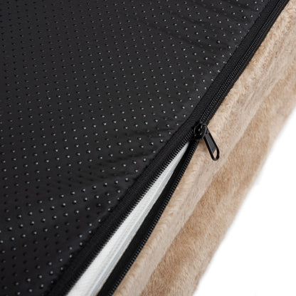 Close-up of beige cushion with black anti-slip underside and partially opened zipper
