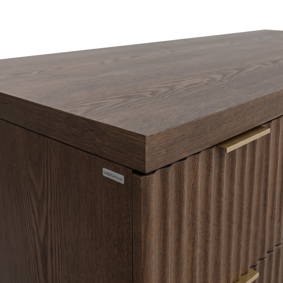 Corner detail of a dark wood cabinet or desk on a white background
