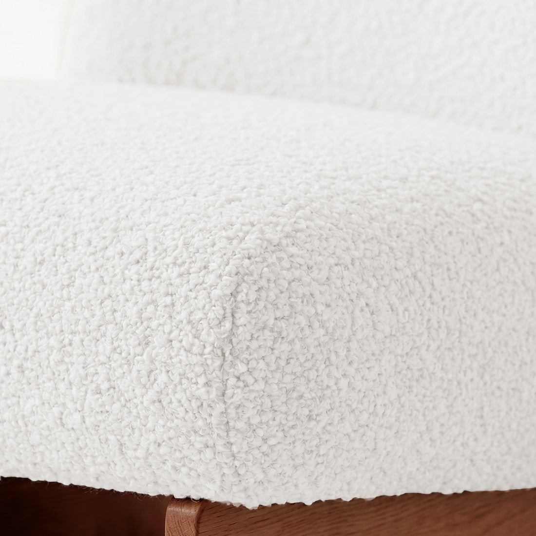 Close-up of seat cushion texture and wooden base.