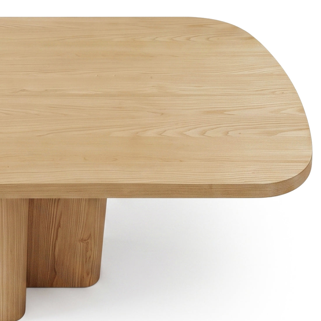 Light wood rectangular table on white background with part of the base cropped