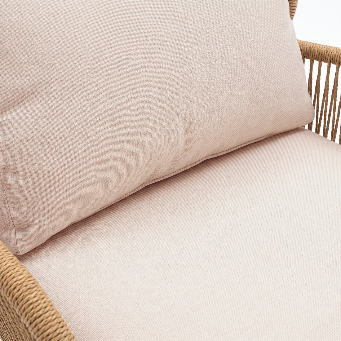 Close-up of a cushioned furniture section with woven frame detail on a white background