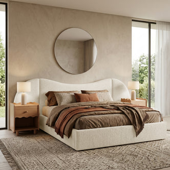 Lifestyle shot of upholstered bed in a styled bedroom with neutral bedding and natural light