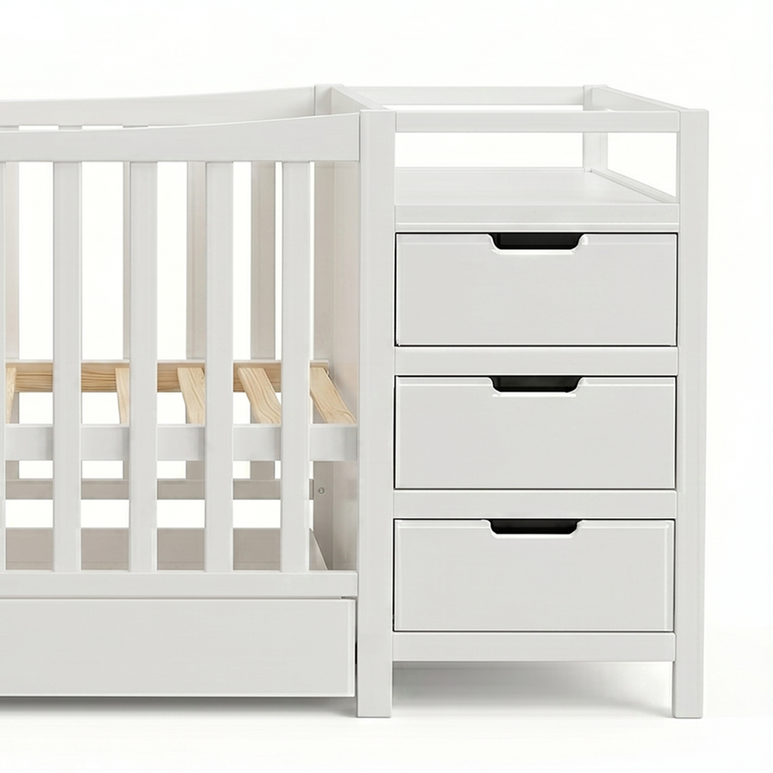 Cropped view of a white crib with drawers on a white background