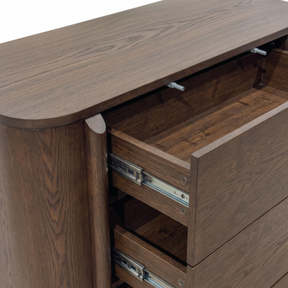 Partial view of a wooden dresser with some drawers open on a white background