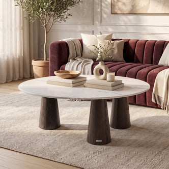 Modern oval coffee table styled in a bright living room with decor and sofa