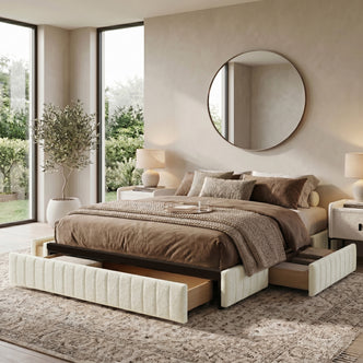 Upholstered storage bed in a decorated bedroom setting with open drawers
