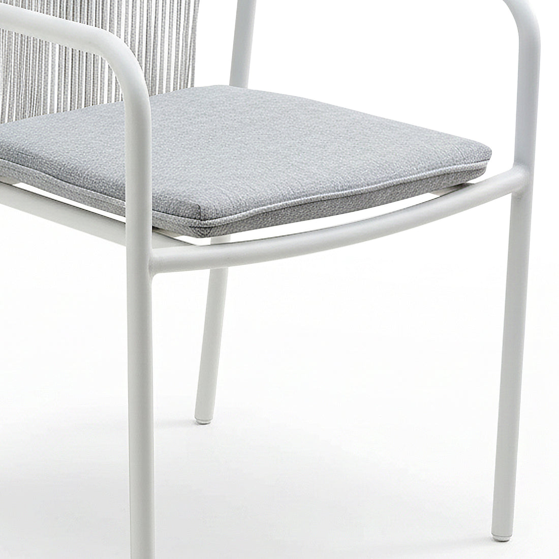 Evone 4 Seater Stone Outdoor Dining Table Set features a modern white metal frame with tubular legs and arms, and a light gray upholstered seat cushion, showcasing sleek outdoor elegance.
