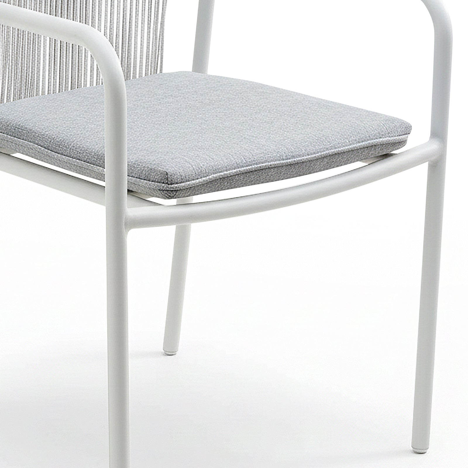 Evone 4 Seater Stone Outdoor Dining Table Set features a modern white metal frame with tubular legs and arms, and a light gray upholstered seat cushion, showcasing sleek outdoor elegance.