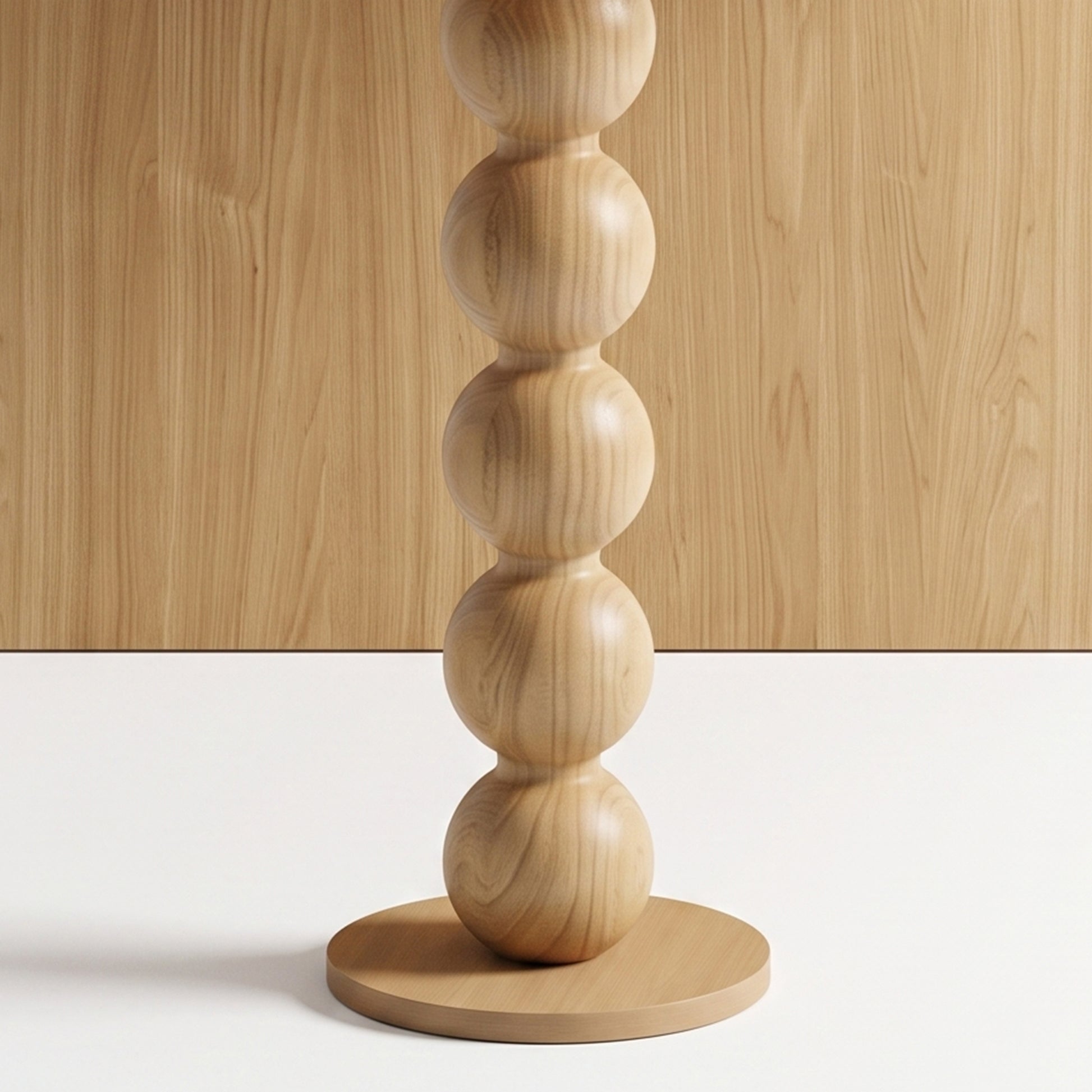 Close-up of a sculptural wooden object with stacked spherical segments on a base