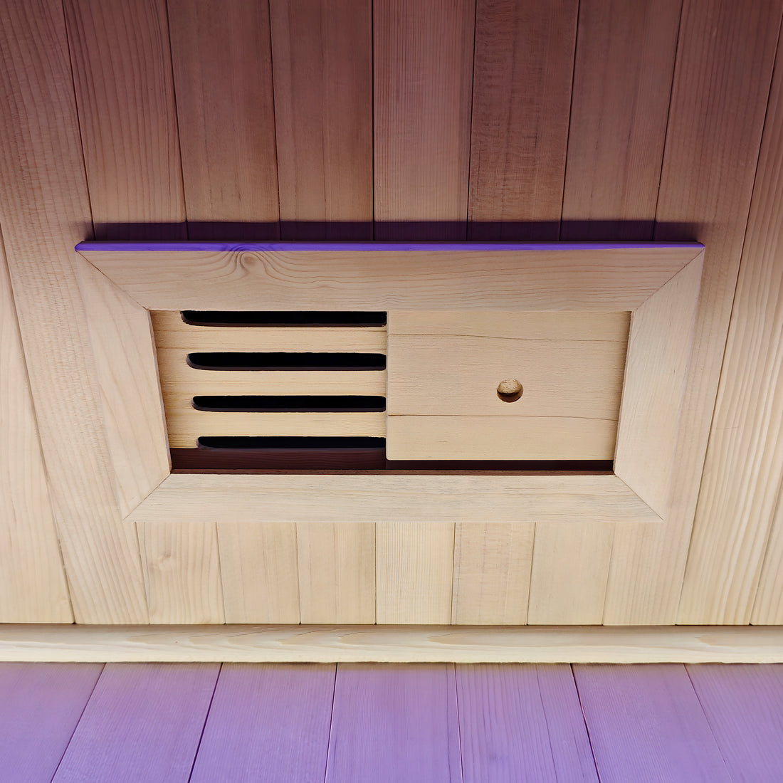 Close-up of a wooden adjustable vent panel in a sauna wall