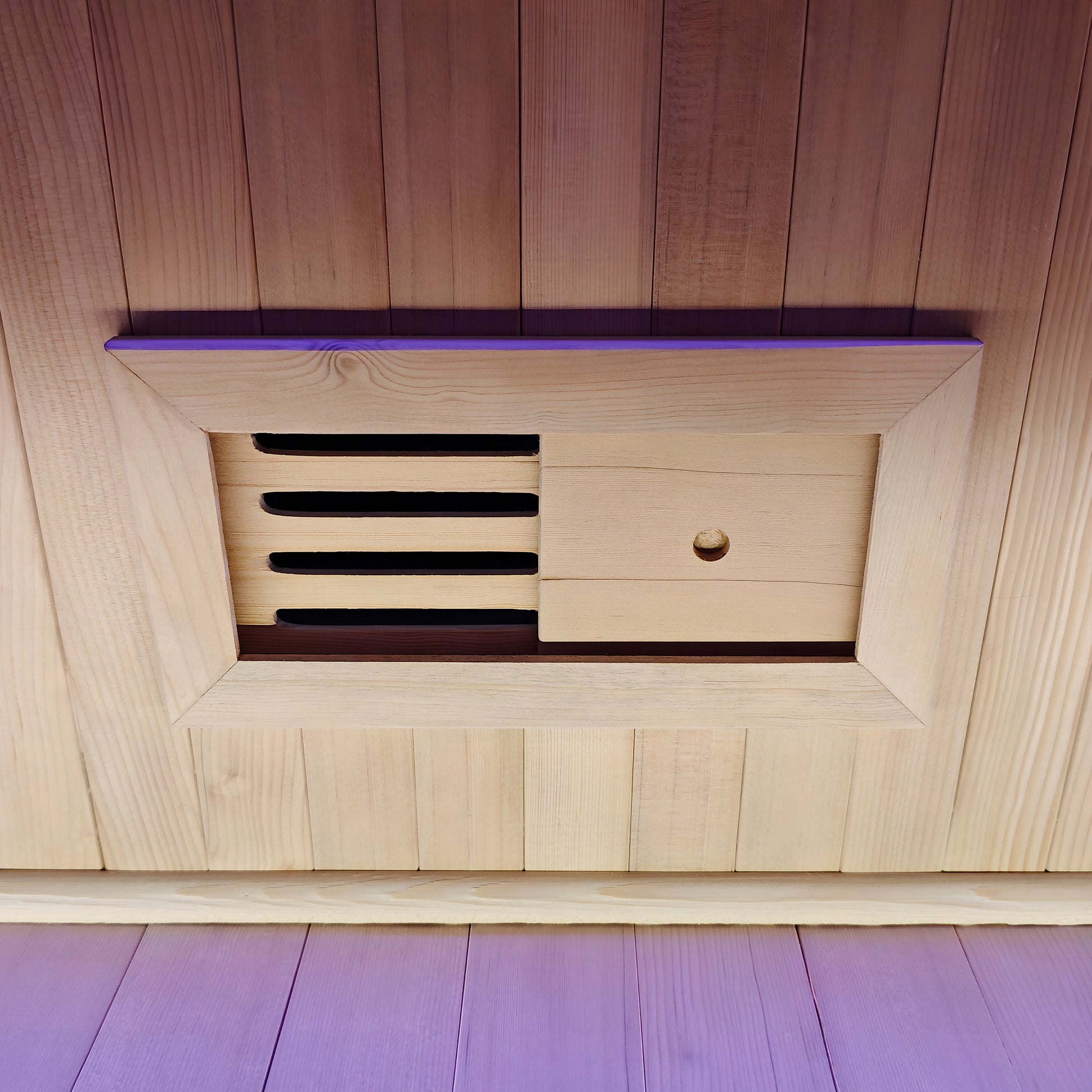Close-up of a wooden adjustable vent panel in a sauna wall