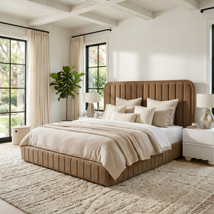 Stylish bedroom featuring the upholstered tan bed with neutral bedding, nightstands, lamps, and decor